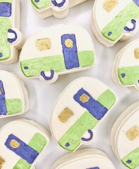 A bath bomb shaped like a camper van in green, purple and white. Hand crafted bath bomb for glamping.  Camper or RV styled bubbly and fizzy bath bomb for bath time fun.