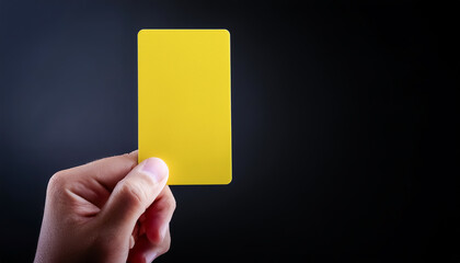 card, yellow, warning, soccer, showing, holding, sports, infraction, foul, serving, black background, closeup