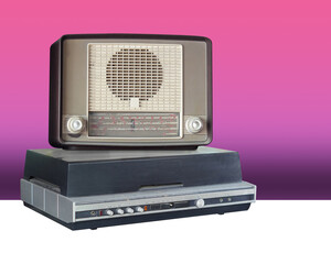 front view antique brown wooden radio on black and silver record player on gradient pink and purple...