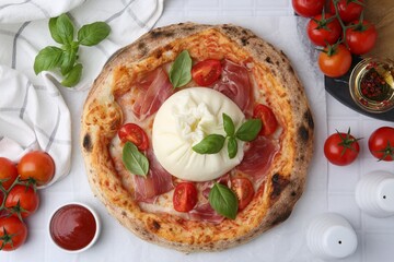 Delicious pizza with burrata cheese served on white tiled table, top view