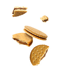 Tasty broken sandwich cookies in air on white background