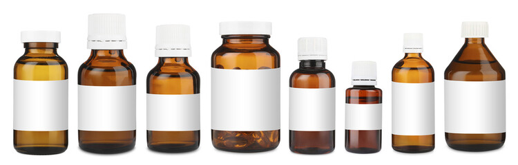 Many different glass bottles with labels isolated on white