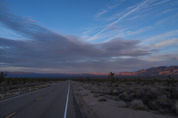 Road through the desert at sunset