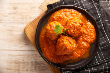 Meatballs in red chipotle chili and tomato sauce, ground pork or beef stuffed with cheese. A very popular homemade food recipe in Mexico and other countries, commonly served with rice.