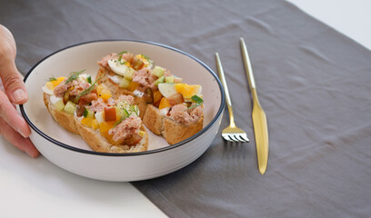 a man's hand serves a plate of breakfast