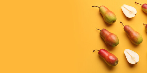 Ripe pears on yellow background