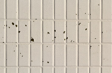 White tiled surface with peeling paint abstract textured background