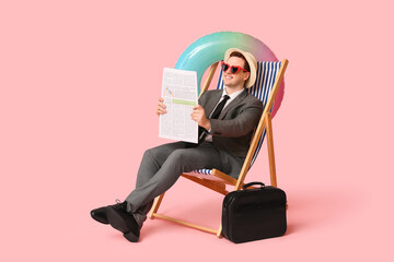 Office worker sitting on deck chair with inflatable ring and newspaper while dreaming about...