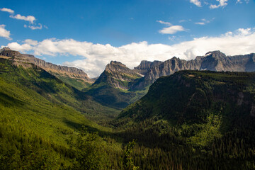 A bench in a small town decorated for Christmas with wreaths, pinecones, and a red bow.
