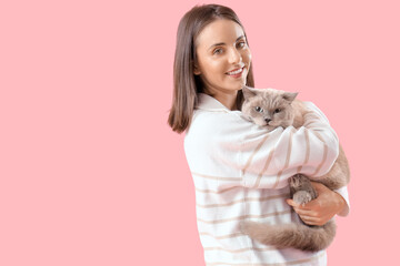 Obraz premium Young woman with cute British Shorthair cat on pink background