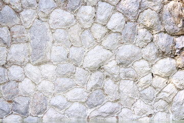 Stone fence wall grey texture  with water on background