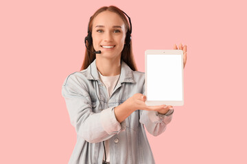 Female technical support agent in headset with blank tablet computer on pink background
