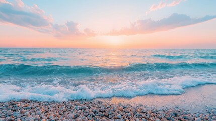 Evening light casts a warm glow over the beach, where smooth pebbles line the shore and gentle waves kiss the sand, creating a tranquil atmosphere at sunset.