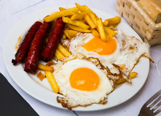 Huevos con chistorra. Scrambled eggs with sausage and potatoes. Spanish cuisine