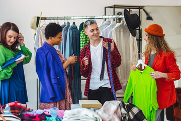 Group of friends generation z girls and boys enjoying shopping in a second hand store or swap home...