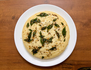 A plate of food (Indian Dhokla) with a green leaf on top