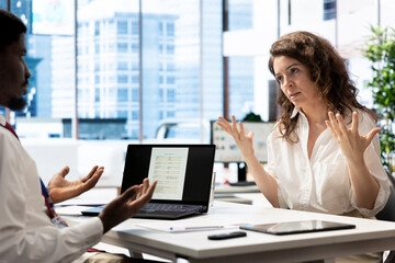 HR employee reading candidate CV, interviewing man to ensure his qualifications align with company...