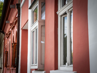 A detailed view of typical Central European windows featuring traditional architectural elements, ornate designs, and symmetrical patterns, highlighting the cultural heritage and historic building sty