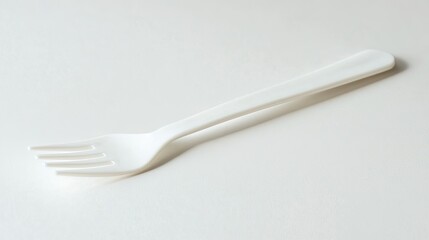Simple White Plastic Fork on Plain Background