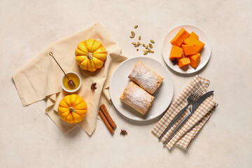 Plate with tasty pumpkin strudel, cinnamon, seeds and bowl of honey on white background