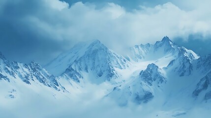 Obraz premium Snowy Mountain Peaks Emerge from a Misty Sky