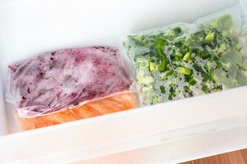 Bag of sliced frozen vegetables in freezer close-up.