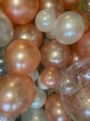 Close-up view of pink and white party balloons filling the frame