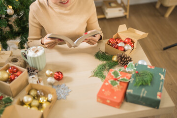Happy woman  reading book celebrating christmas at home relax Xmas holiday