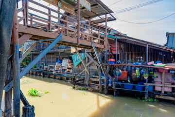 Background of high angle view from wooden bridge in community market area crossing canal at tourist attraction, community lifestyle of people living together in a mutually beneficial way.