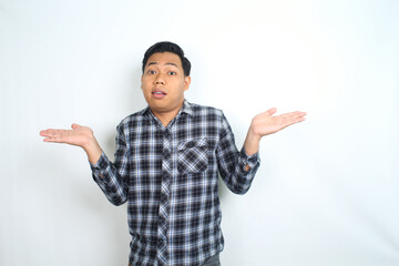 confused asian young man shrugging and raising hand show i dont know gesture wearing casual plaid shirt isolated on white background
