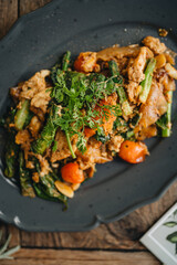 A plate of Thai flat noodles with chicken