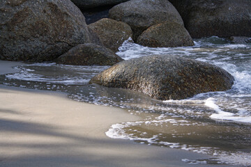 Beautiful soft wave on a rocky beach. Beach sand with soft wave. Summer vacation concept