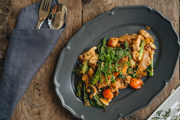 A plate of Thai flat noodles with chicken