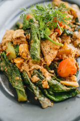 A plate of Thai flat noodles with chicken