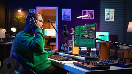 Professional artist writes new verses for a song in home studio, producing new music with mixing...