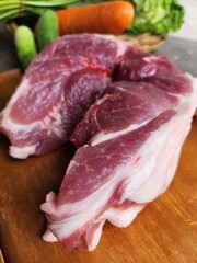 Raw pork and vegetable on wood board