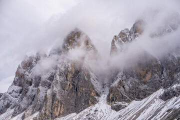 View of fog with mountain Geisler peaks in the Dolomites, Italy.