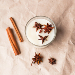 Christmas composition soy wax handmade candles in glass jars, soy candles decorated with star anise, cinnamon and dried oranges. Home therapy and relaxing concept. Scented candle, aesthehic product