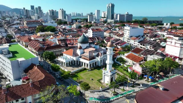 Kapitan keling mosque with cityscape in georgetown, penang on a sunny day, aerial view