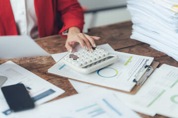 Financial Analyst at Work: Close-up of a woman's hands meticulously working with a calculator...