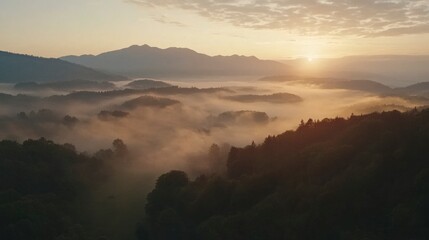 Fototapeta premium Aerial view of misty mountains at sunrise