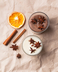 Christmas composition soy wax handmade candles in glass jars, soy candles decorated with star anise, cinnamon and dried oranges. Home therapy and relaxing concept. Scented candle, aesthehic product