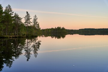 Serene lake landscape at sunset with reflections.