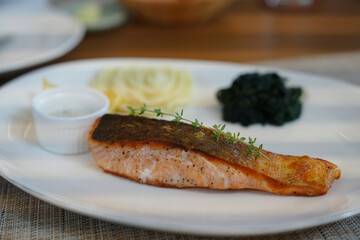 Baked salmon , salmon steak with potatoes on white wine sauce.