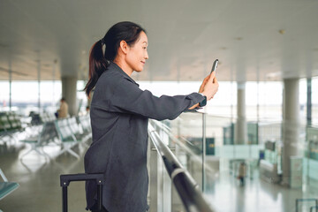 Capturing Moments: A Woman Taking Photos at the Airport