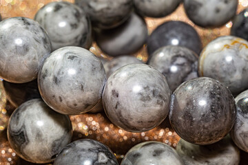 Beautiful round beads of gray jasper in macro photography, perfect for crafting and jewelry design. Decorative round stone beads of gray color  for boho jewelry design.