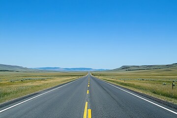 Fototapeta premium Endless road stretching into distance under blue sky