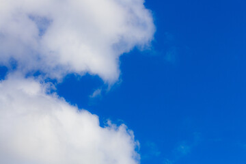 White heap clouds in the blue peaceful sky. The concept of psychological calmness and health. Peace of mind with the forces of nature. Air travel concept.