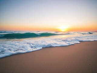 A soft blue ocean wave breaks on the shore of a tranquil fine sandy beach at sunset, creating a beautiful and serene scene, coastal scenery, natural beauty, shoreline