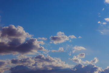 White heap clouds in the blue peaceful sky. The concept of psychological calmness and health. Peace of mind with the forces of nature. Air travel concept.